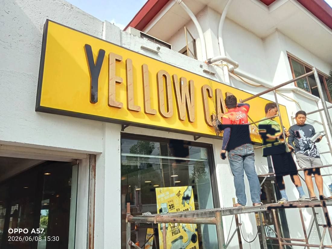 Yellow Cab lightbox letters being installed